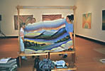 cutting the tapestry off the loom in Two Rivers Art Gallery, Prince George, BC